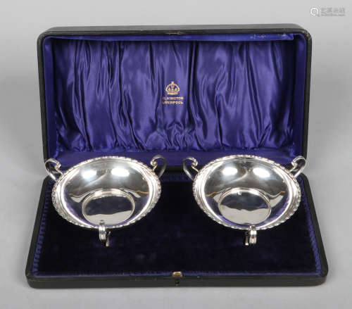 An Edwardian cased pair of silver bon bon dishes by Elkington and Co. Each with gadrooned rim and