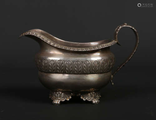 A George III silver cream jug by Joseph Angell I. With gadrooned rim, scrolling acanthus handle,