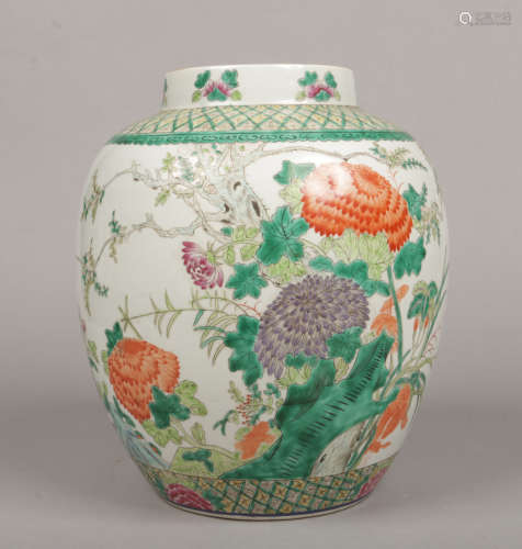 A large 20th century Chinese famille verte jar. Painted with two trellis bands framing a central