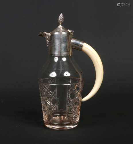 An early 20th century small cut glass decanter with silver plated mounts and tusk handle, 18.25cm.