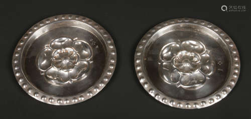 A pair of Victorian embossed silver plaques by Child & Child. With beadwork rims and decorated to