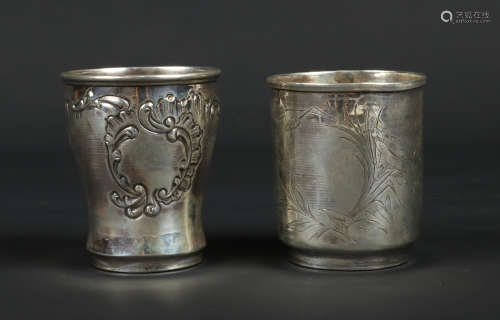 Two French silver christening beakers. One with embossed scrolls and flowers and the other chased