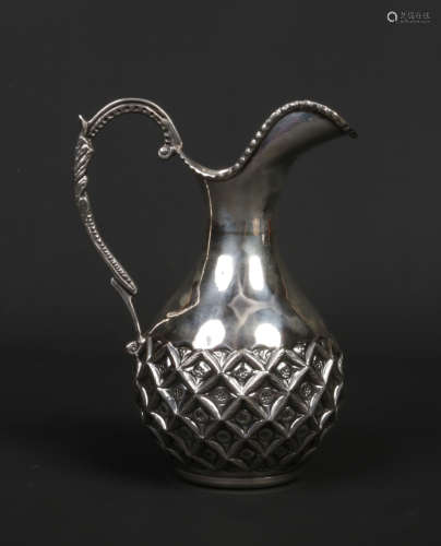 A Continental silver ewer. Embossed with a pattern of stylized leaves and with beaded rim and double