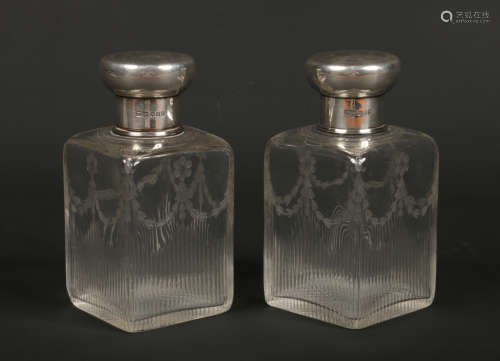 A large pair of George V cut and etched glass scent bottles with silver stoppers on threaded