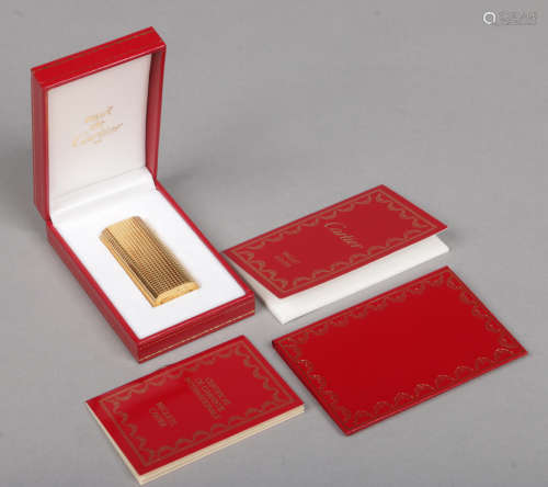 A Cartier must de gold plated lighter, with knurled grip, in box and with papers.Condition report