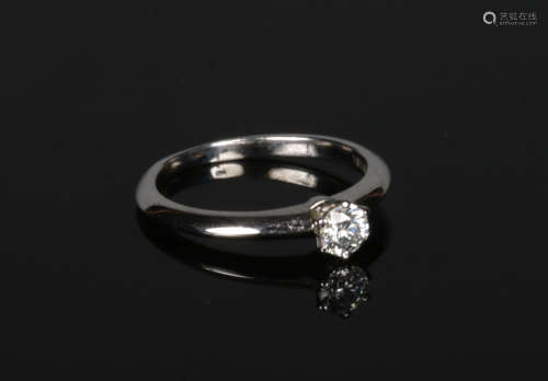 A Tiffany & Co. platinum and diamond solitaire engagement ring. Claw set with a brilliant cut