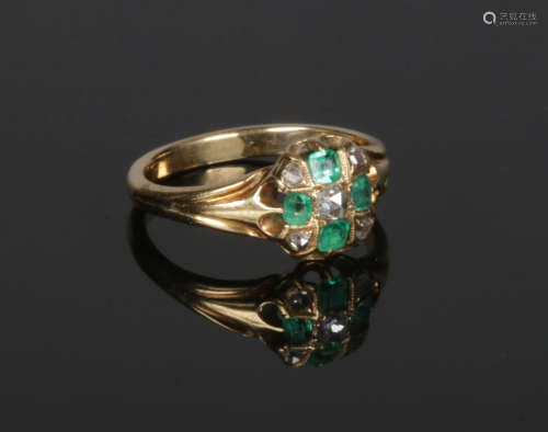 A Victorian gold emerald and diamond cluster ring with reeded shoulders. 3.58 grams, size L.