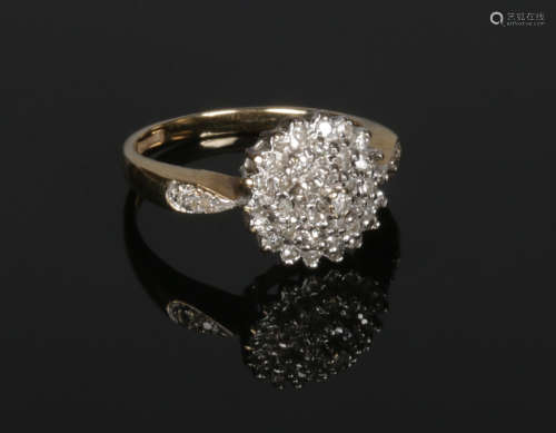 A 9 carat gold diamond cluster ring. Size L.