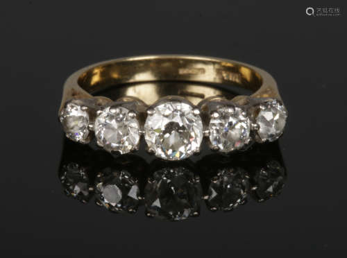 An 18 carat gold five stone diamond ring. Set with five graduated Old European cut diamonds.