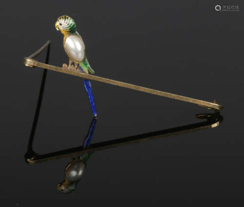 A 15 carat gold bar brooch surmounted with a budgerigar enamelled and set with a split pearl.