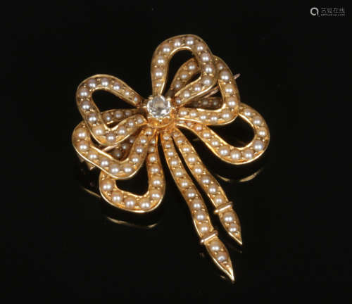 A 15 carat gold diamond and seed pearl brooch formed as a triple bow. 8.64 grams, 38mm.