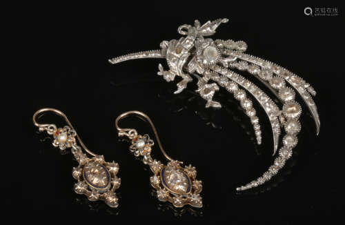 An antique white metal and rose cut diamond spray brooch and similar pair of lozenge shaped earrings
