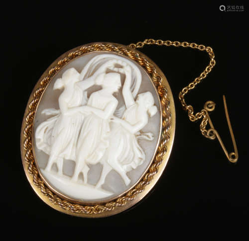 A 9 carat gold mounted carved shell cameo brooch. With ropetwist border and depicting the three
