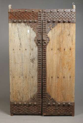 A pair of early 19th century Chinese hardwood doors with iron mounts, each 170cm x 52cm.
