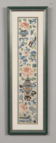 A pair of Chinese framed silk embroidered panels depicting flowers, 48cm x 8cm.