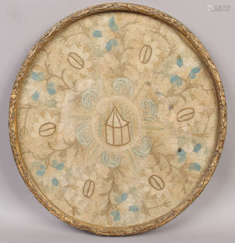 A 17th century crewelwork picture in oval gilt frame. Depicting a wide border of flowers framing a