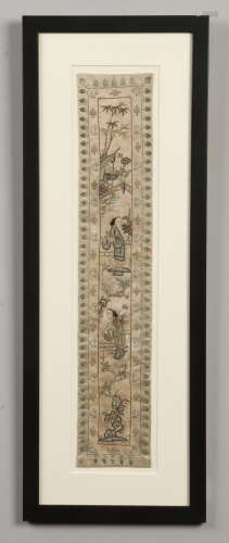 A pair of framed Chinese silk embroidered panels. Each depicting figures in garden landscapes,