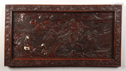 An early 20th century Chinese carved hardwood panel. Decorated in relief with two figures in an