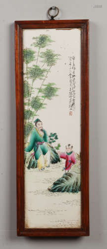 A pair of 20th century Chinese porcelain panels in wooden frames. Decorated in coloured enamels with