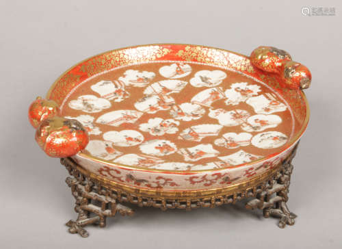 A Japanese Meiji period Kutani dish on gilt bronze faux bamboo stand. With twin gourd handles and