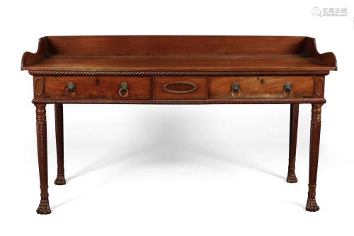 An Irish Regency mahogany sideboard. With reeded and twist carved mouldings, having two drawers in
