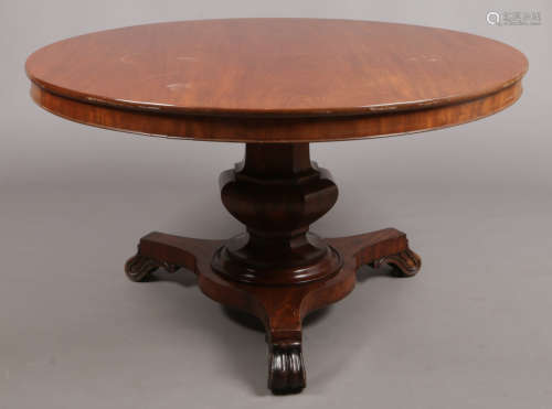A Victorian mahogany fold over breakfast table. Raised on an octagonal column support over a triform