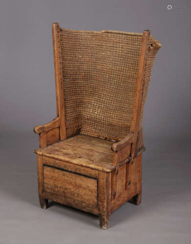 A 19th century Orkney jointed pine armchair on single drawer box base and with oat straw back,