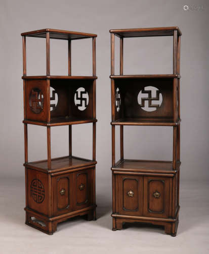 A pair of early 20th century Chinese four tier hardwood bookcases / display stands. Each raised on a