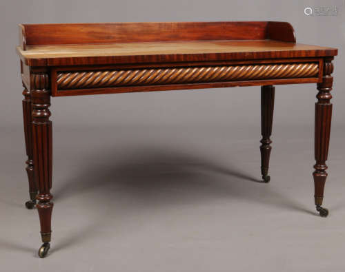 A William IV Gillows style mahogany side table. With gallery, twist carved frieze and raised on