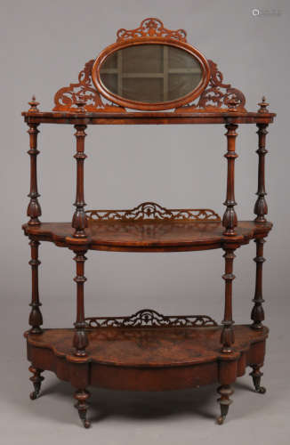 A Victorian figured walnut three tier demi lune whatnot stand with mirrored back and single