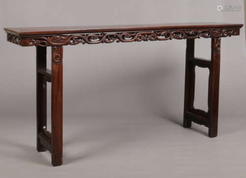 A large 19th century Chinese hardwood alter table with carved openwork scrolling frieze, 210cm wide,