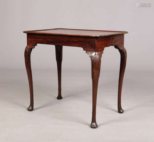 A George II Irish mahogany dish top silver table. Raised on cabriole supports with carved shell