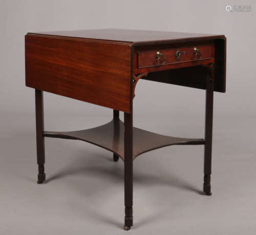 A Regency mahogany single drawer Pembroke table. With axe head handles and raised on square supports