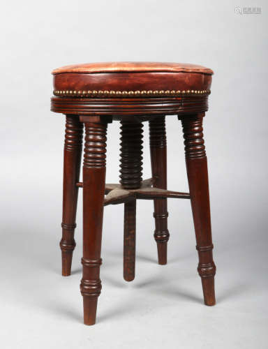 An early Victorian mahogany rise and fall piano stool. With leather seat and ring turned splay