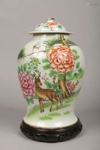 A large Chinese late 19th / early 20th century baluster shaped jar and cover raised on a hardwood