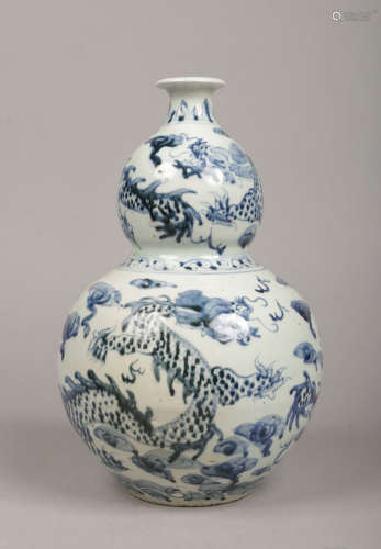 A Chinese blue and white double gourd shaped vase of Wanli style. Painted in underglaze blue with