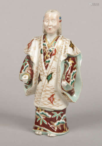 A Japanese Meiji period polychrome porcelain figure of an actor wearing a noh mask and dressed in
