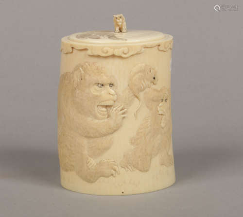 A Japanese Meiji period ivory tusk jar and cover. Carved in light relief with three chimpanzees