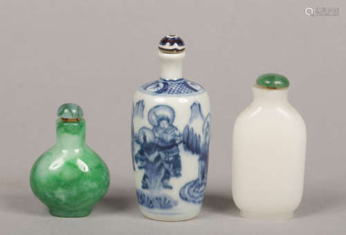 Three Chinese late Qing Dynasty snuff bottles. One painted in underglaze blue with deities, one
