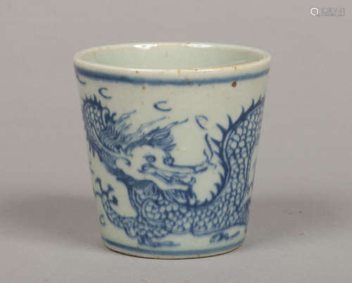 An antique Chinese blue and white beaker of tapering form. Painted in underglaze blue with a