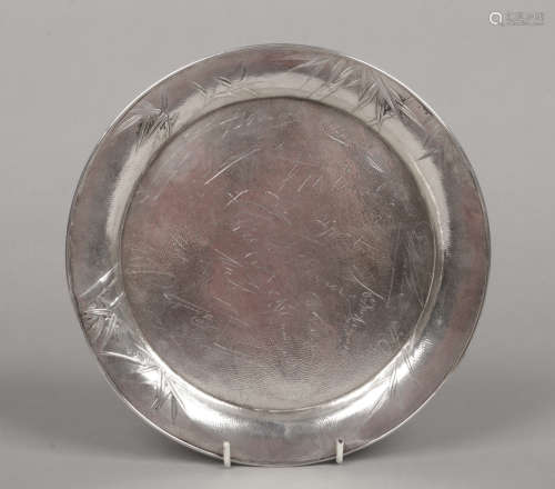 A planished sterling silver dish embossed to the rim with bamboo shoots. Engraved to the centre with