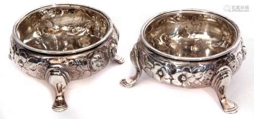 Two mid-Victorian cauldron salts, each with embossed floral and foliate bodies on three cast and