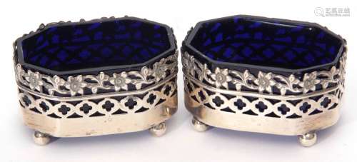 Two late Victorian open salts each of hexagonal form with foliate pierced rims and raised on ball