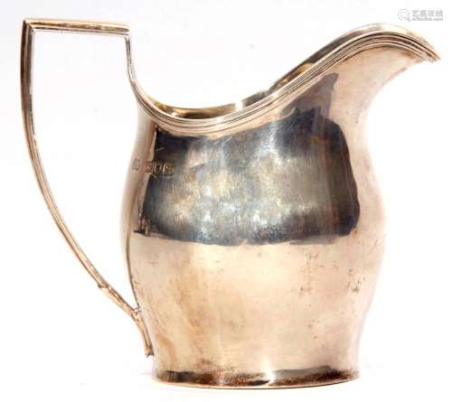 George V helmet shaped milk jug, the plain and polished body with applied reeded rim and handle,