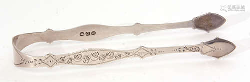 Pair of late George III sugar tongs of shaped and engraved form with vacant cartouche to the bridge,