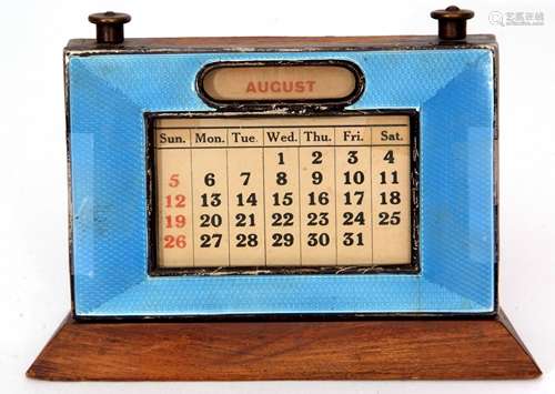 George V guilloche enamelled desk calendar, the rectangular frame on a flared base with an applied