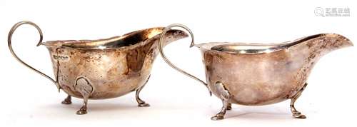 Two Elizabeth II sauce boats of typical polished form with cut card rims, strapwork handles and