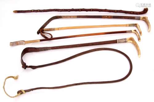 Mixed Lot: comprising four various antler handled riding crops, two with signed buttons for Swaine &