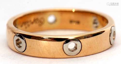 A 750 stamped two-tone ring, a plain polished design featuring six pierced hexagonal shaped holes,