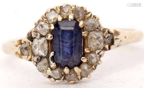 Antique sapphire and diamond cluster ring with a central rectangular shaped sapphire, within an